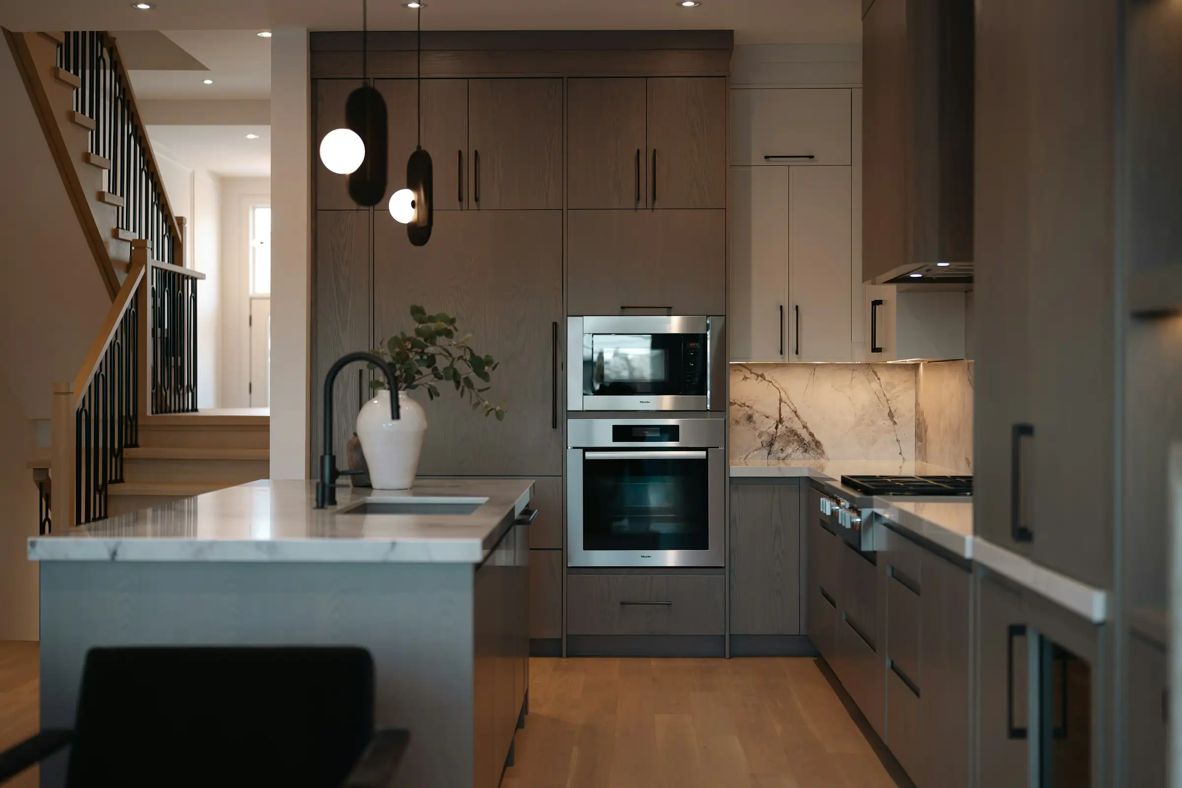 Kitchen cabinet remodel shown from a second angle with soft-close cabinets and hanging lights