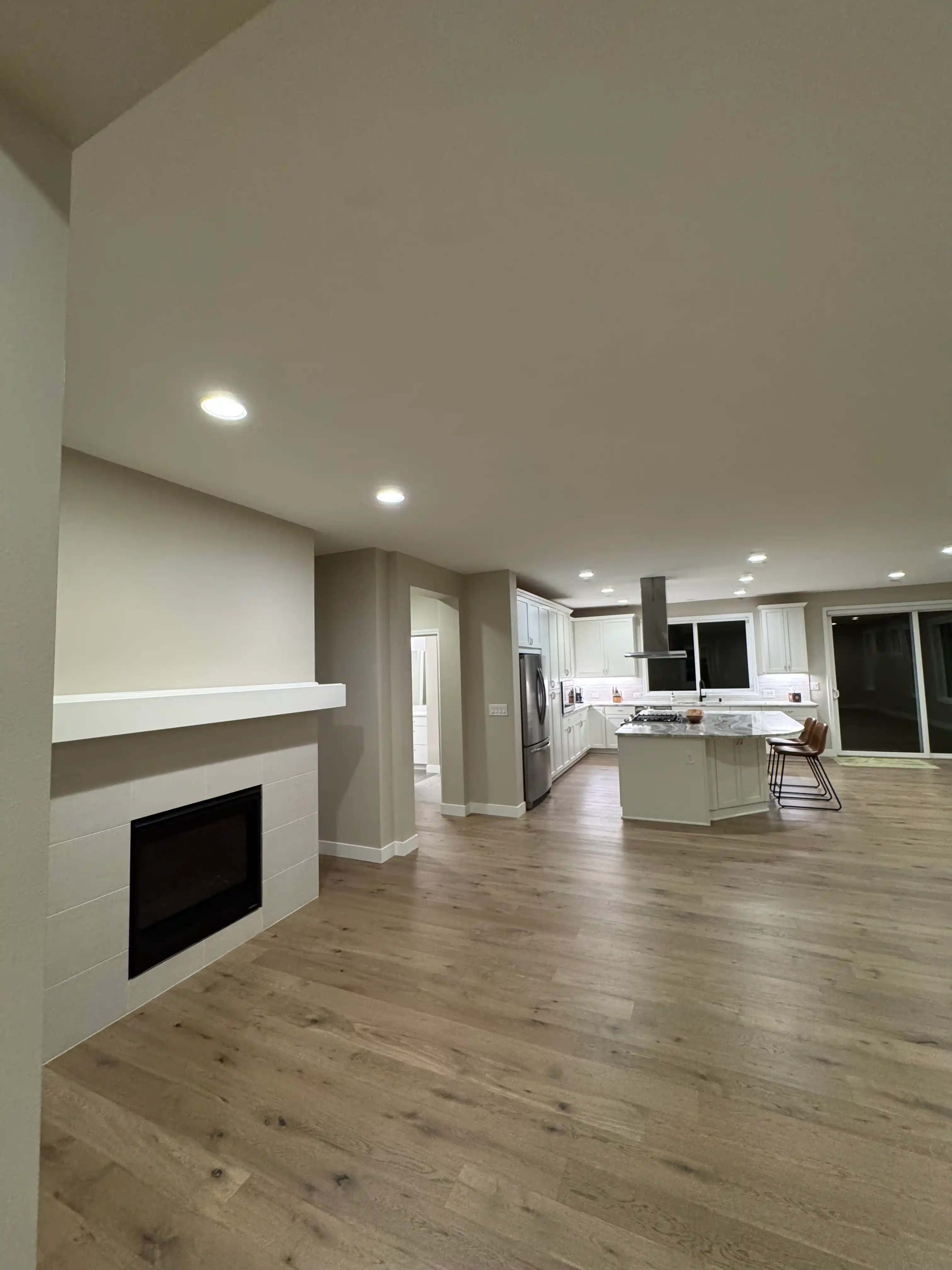 Living room and kitchen flooring remodel in gray-toned wood
